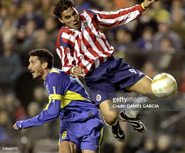 Boca Juniors' Diego Cagna and Chivas of Guadalajara's Omar Bravo vie for the ball 14 June, 2005 during their Libertadores Cup quarterfinals match at...