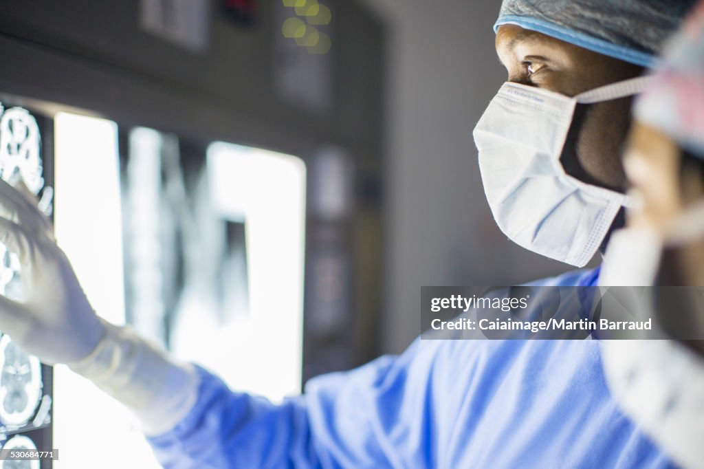 Mid adult man examining patients MRI