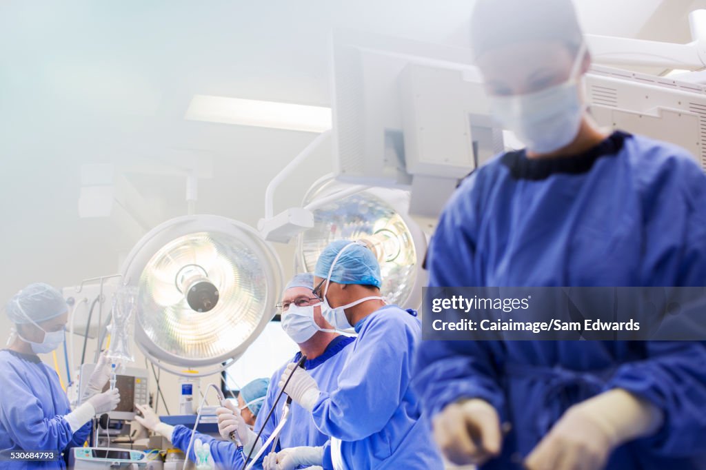 Young nurse preparing medical equipment during surgery