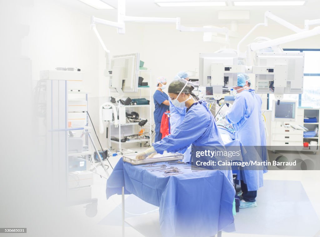 Team of surgeons performing surgery in operating theater