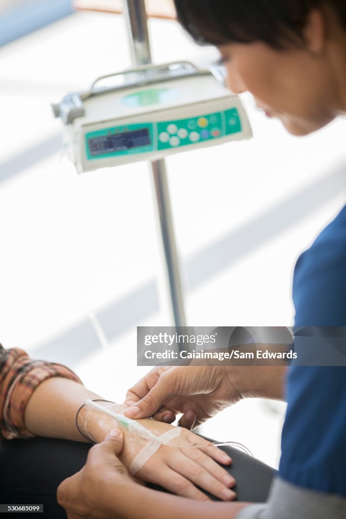 Doctor administering intravenous infusion to patient