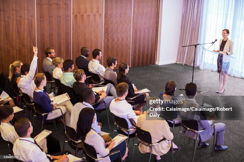 Mid adult businesswoman giving presentation in conference room