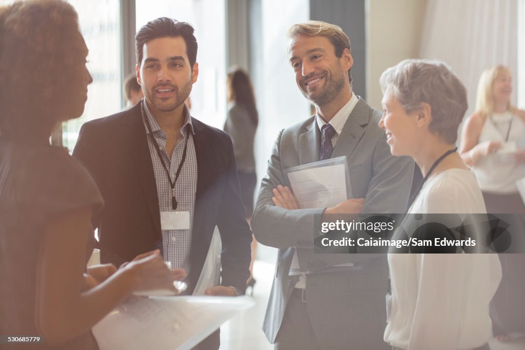 Group of business people smiling and discussing in office