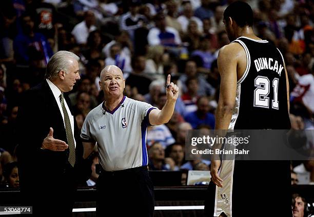 Official Joe Crawford talks with head coach Gregg Popovich as Tim Duncan watches from the court in the first half against the San Antonio Spurs of...