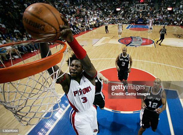 Ben Wallace of the Detroit Pistons slam dunks the basketball against the San Antonio Spurs defense in the fourth quarter of Game three of the 2005...