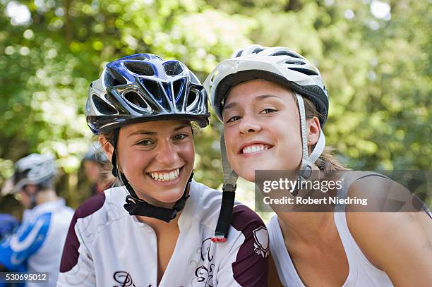 two teenage girls wearing bicycle helmets, sonthofen, schattwald, bavaria, germany - teenager cycling helmet stock pictures, royalty-free photos & images