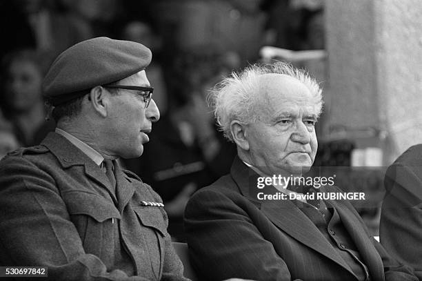 David Ben-Gurion sits next to Zvi Tzur at a military reception in Israel.