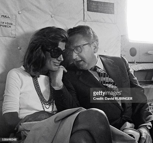 On a helicopter during the period of "shuttle diplomacy" in the Middle East, Henry Kissinger talks to his wife Nancy.