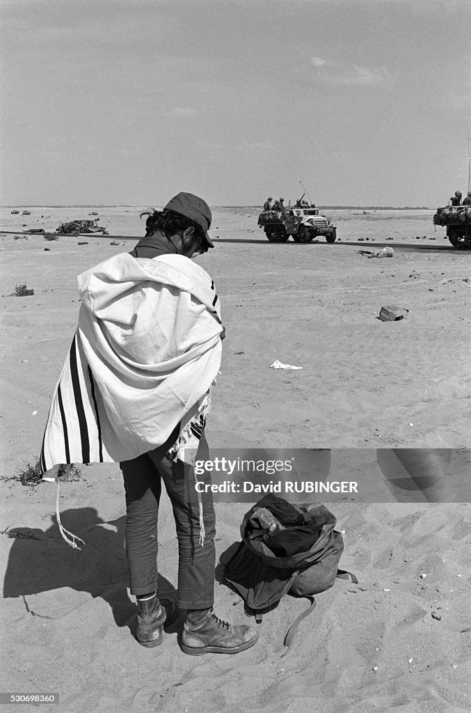 Soldier Prays in Desert