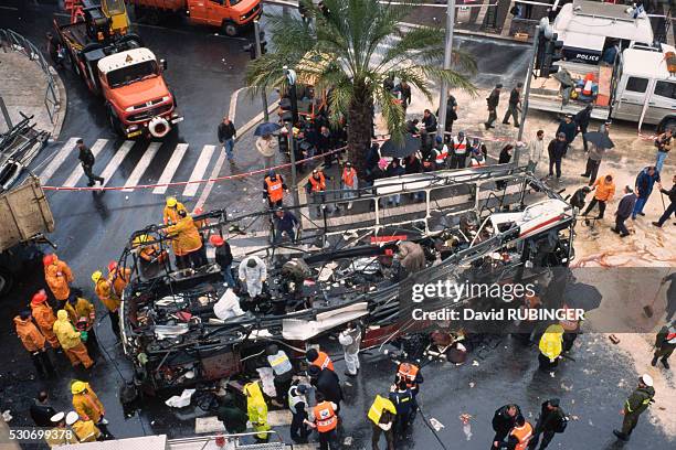 Rescue workers and police officers gather around a bus that was the target of a suicide bombing in Jerusalem. Numerous similar attacks have been...