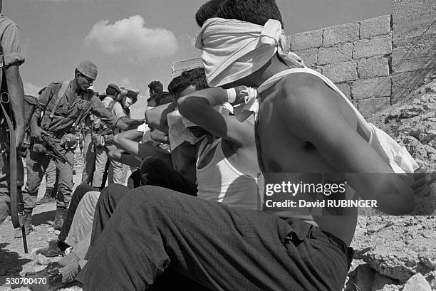 Masked Palestinain prisoners captured during an Israeli operation to uncover and capture members of the Movement for the National Liberation of...