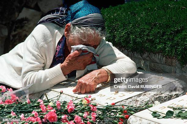 Mother weeps over her son's grave in the Mount Herzl military cemetery, on Independence Day.