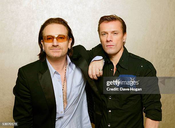 Former Live Aid artists, U2 members Bono and Larry Mullen Jr., pose for a portrait to commemorate the 20th anniversary of Live Aid, on June 14, 2005...