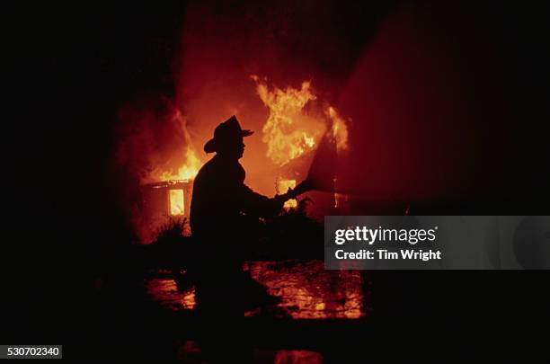 silhoutte of a firefighter - firemen at work stock pictures, royalty-free photos & images
