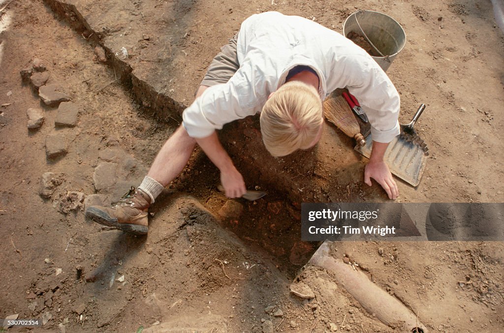 Archaeologist Digging at Site