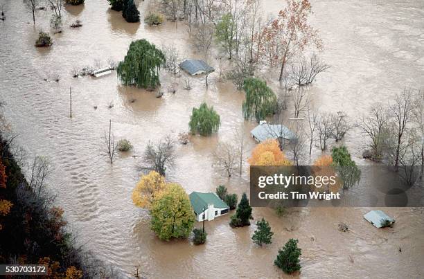 an aerial view of houses surrounded by flood water - översvämmad bildbanksfoton och bilder