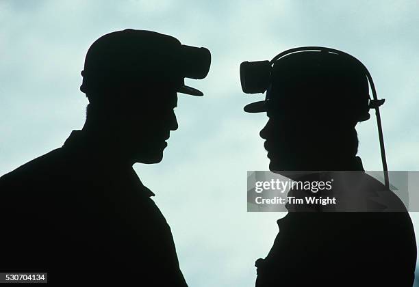 silhouette of coal miners - mineur de charbon photos et images de collection
