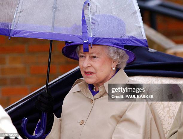 Britain's Queen Elizabeth arrives with her umberella on the second day of the Royal Ascot at York Racecourse, Britain, 15 June 2005. The Royal Ascot...