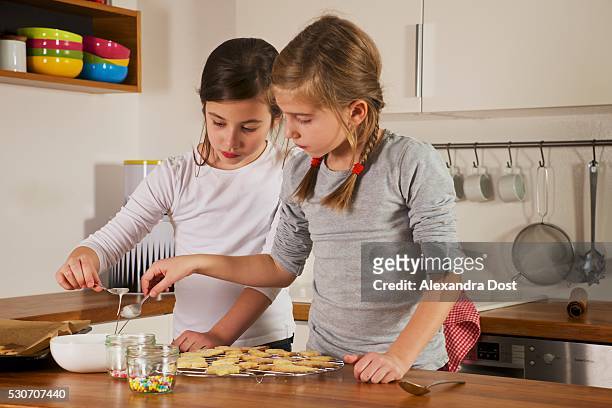 children making christmas cookies, munich, bavaria, germany - alexandra dost stock-fotos und bilder