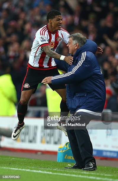 Patrick van Aanholt of Sunderland celebrates scoring his team's opening goal with manager Sam Allardyce during the Barclays Premier League match...