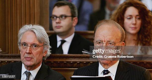 Rupert Murdoch sits alongside Les Hinton Andy Coulson News of The World editor, and Rebekah Wade, editor of The Sun in the service at St Brides...