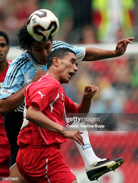 Mario Santana of Argentina heads before Anis Ayari of Tunisia during the FIFA Confederations Cup Match between Argentina and Tunisia on June 15, 2005...