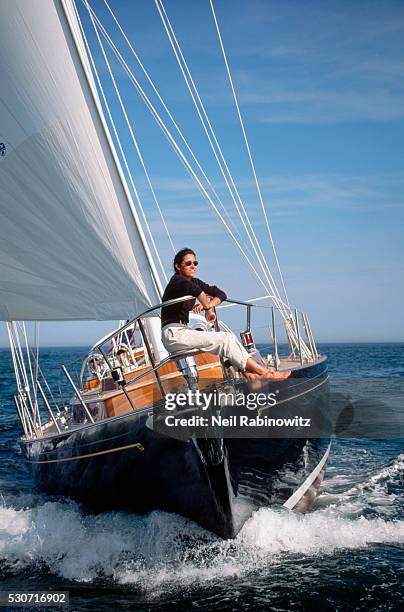 woman riding on the bow of a yacht - sailor stock pictures, royalty-free photos & images