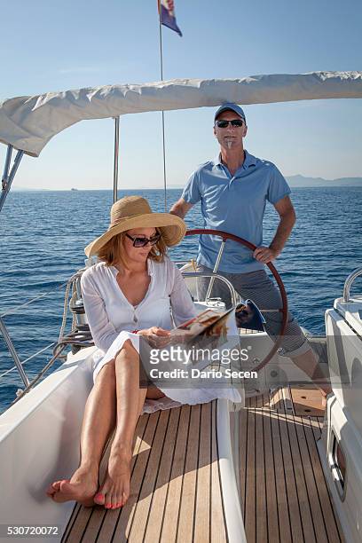 mature couple on sailboat, using digital tablet, adriatic sea, croatia - magazine retreat day 2 stock pictures, royalty-free photos & images