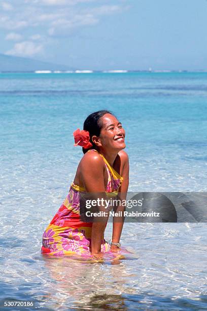 woman wading in the water - tahiti flower stock pictures, royalty-free photos & images