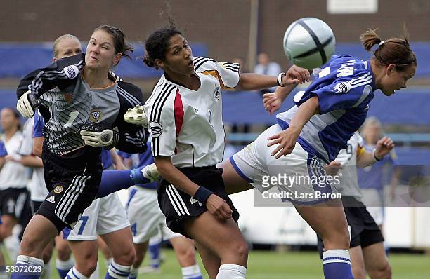 Stephanie Jones from Germany goes up for a header with goalkeeper Satu Kannus and Tiina Salmen from Finland during the UEFA Women's European...