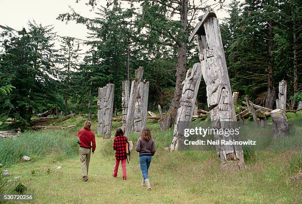 visiting ruins of native village - haida gwaii totem poles stock pictures, royalty-free photos & images