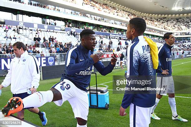Serge Aurier of Paris SG talks to Christopher Nkunku before the French Ligue 1 match between FC Girondins de Bordeaux and Paris Saint-Germain at...
