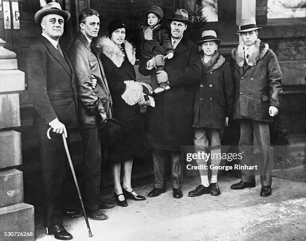 The newly elected governor of New York, Franklin D. Roosevelt, arrives at the executive mansion in Albany with some family members. From left to...