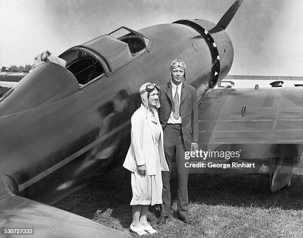 Pilot Charles Lindbergh and his wife, Anne, stand by their plane after arriving at Curtiss Airport in Glenview, Illinois.