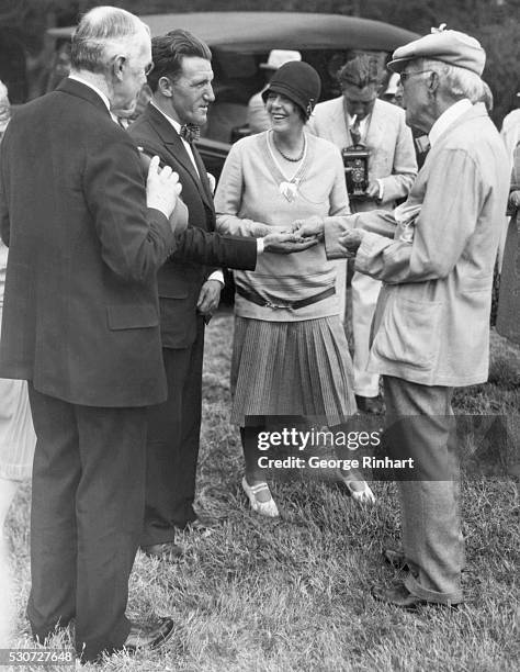 Ormond Beach, FL: Portrait of John D. Rockefeller distributing nice, shiny new dimes to some of his friends. Photo taken on his private golf course...