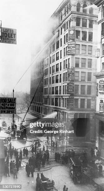 Fire fighters try to put out the 1911 catastrophic fire at the Triangle Shirtwaist Factory Building which killed 146 workers as a result of looked...