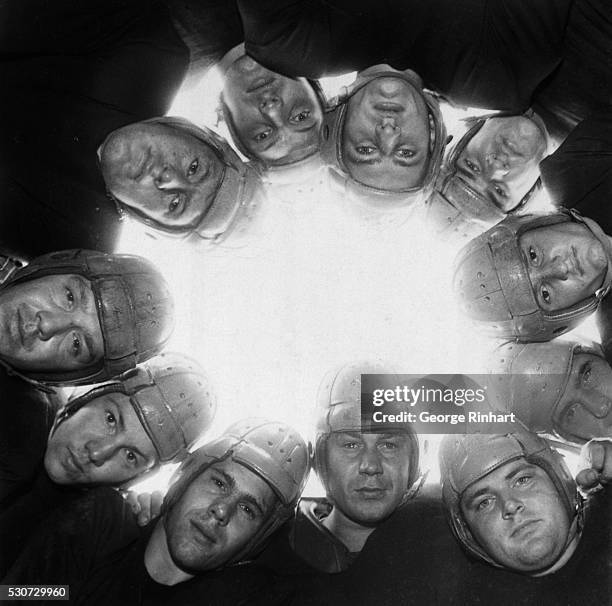 Team members of the University of Illinois Fighting Illini in a huddle.