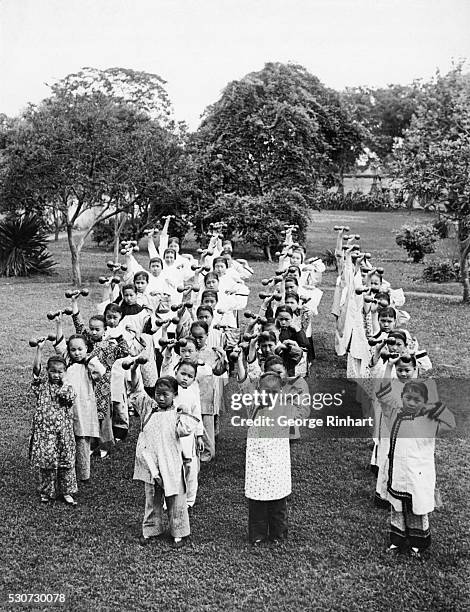 Shanghai, China: Portrait of Chinese children exercising at a Presbyterian mission school. Undated photograph.