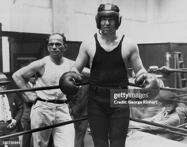 Los Angeles, CA- Jack Dempsey in his old ring togs with his trainer, Jerry the Greek . The ex-champ still keeps in training. He's going to be in the...