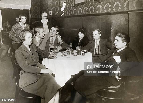 Group of German women assert their equality by smoking cigars and dressing as men during a meeting of a smoking club at a Berlin cafe.