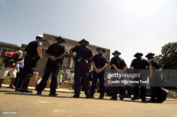 Philadelphia police stand guard outside the Neshoba County Courthouse during the trial of Edgar Ray Killen on June 15, 2005 in Philadelphia,...