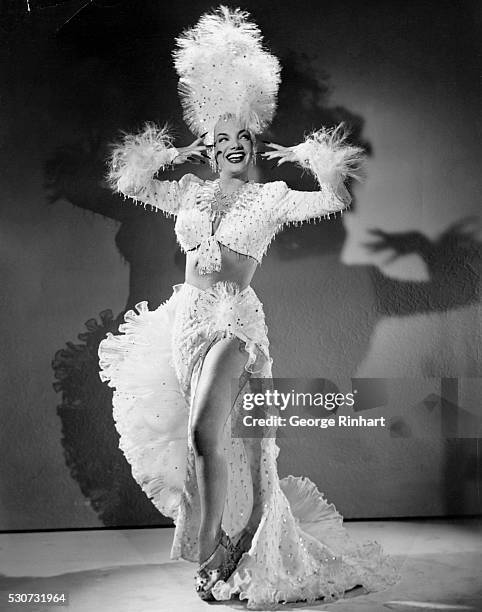 BRAZILIAN BOMBSHELL,CARMEN MIRANDA,"YOU'RE FOR ME," - 20TH CENTURY FOX FILM. THE SINGER AND ACTRESS IS DRESS IN A SPARKLY 2 PIECE WHITE DRESS TRIMMED...