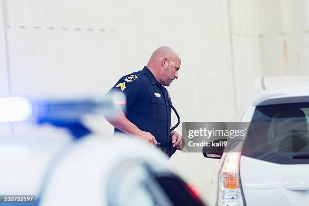 police officer talking to driver of car he pulled over - conversation car bildbanksfoton och bilder