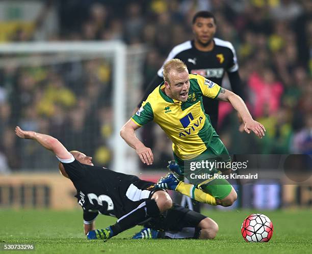 Steven Naismith of Norwich City is challenged by Ben Watson of Watford during the Barclays Premier League match between Norwich City and Watford at...