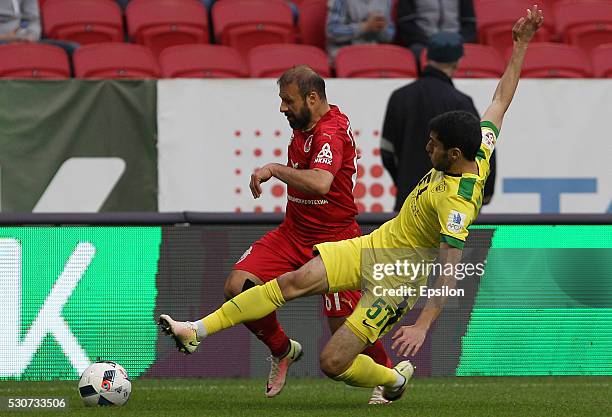 Gokdeniz Karadeniz of FC Rubin Kazan challenged by Amadou Moutari of FC Anzhi Makhachkala during the Russian Premier League match between FC Rubin...