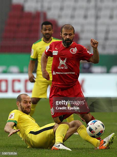 Gokdeniz Karadeniz of FC Rubin Kazan challenged by Ivan Mayewski of FC Anzhi Makhachkala during the Russian Premier League match between FC Rubin...