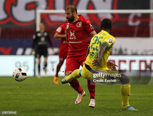 Gokdeniz Karadeniz of FC Rubin Kazan challenged by Jonathan Mensah of FC Anzhi Makhachkala during the Russian Premier League match between FC Rubin...