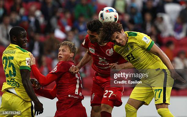 Magomed Ozdoyev of FC Rubin Kazan challenged by Georgi Tigiyev of FC Anzhi Makhachkala during the Russian Premier League match between FC Rubin Kazan...