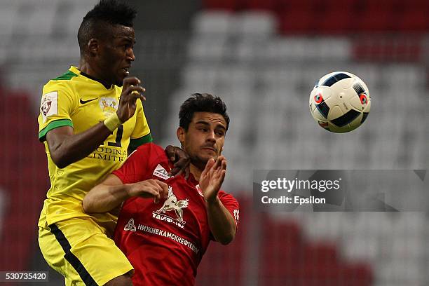 Guillermo Cotugno of FC Rubin Kazan challenged by Amadou Moutari of FC Anzhi Makhachkala during the Russian Premier League match between FC Rubin...