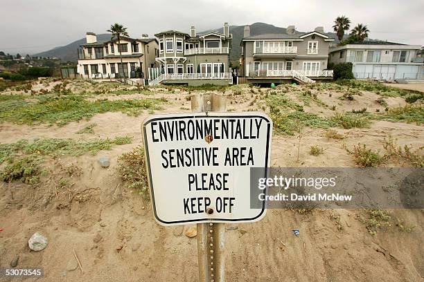 Sign warns of an environmentally sensitive area on exclusive beachfront properties behind the public beach on June 15, 2005 in Malibu, California....